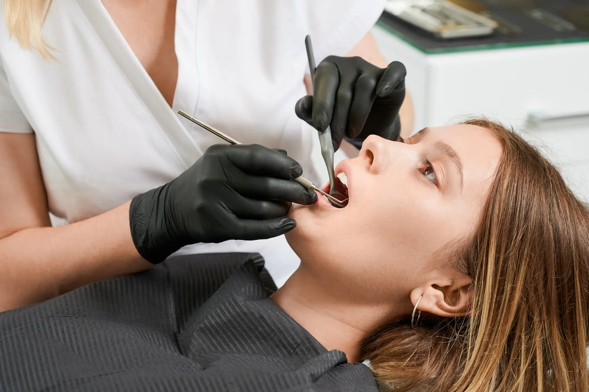 female-doctor-examining-patient-teeth-dental-clinic (1).webp