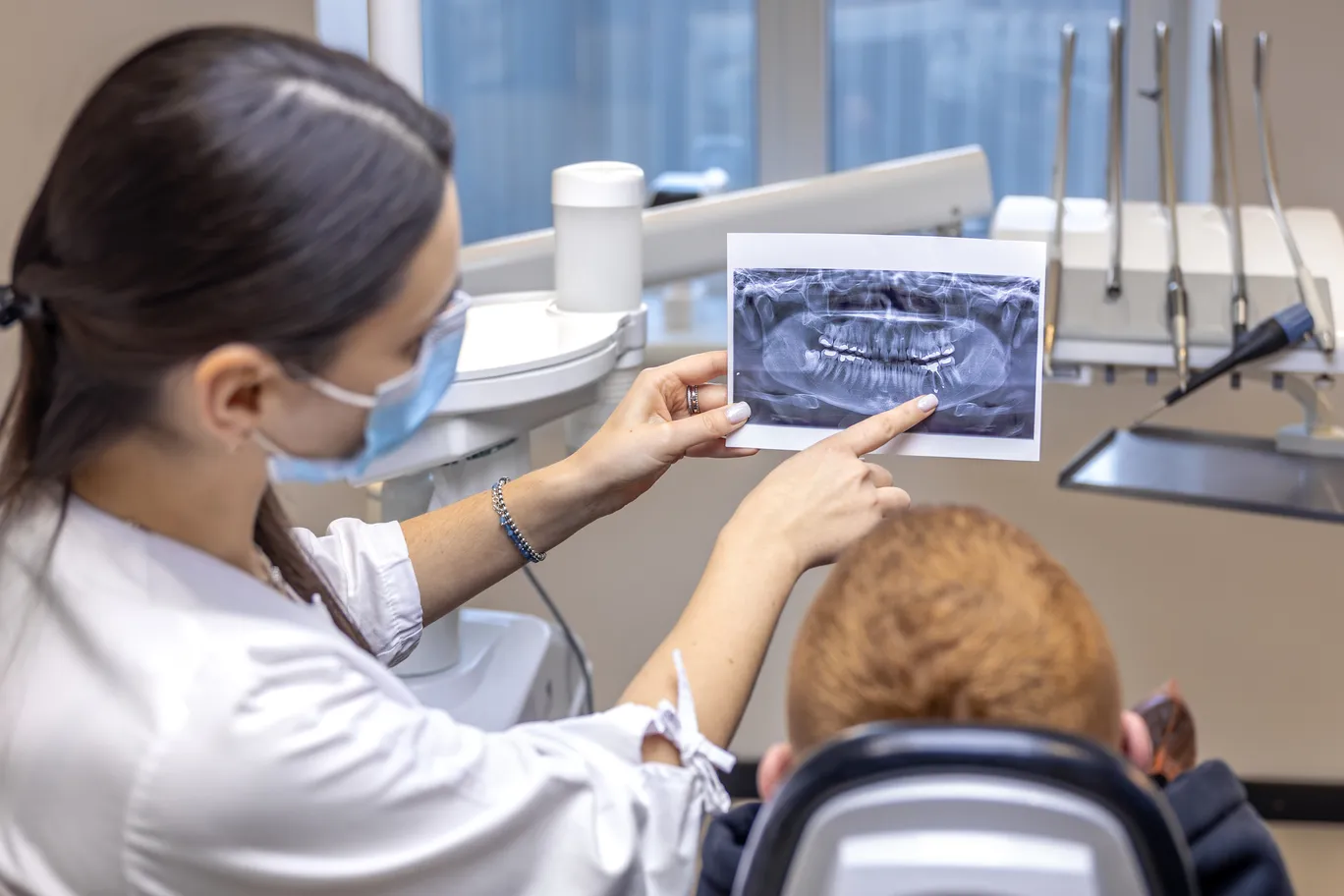 young-female-dentist-showing-patient-dental-xray-dentistry-concept (1).jpg