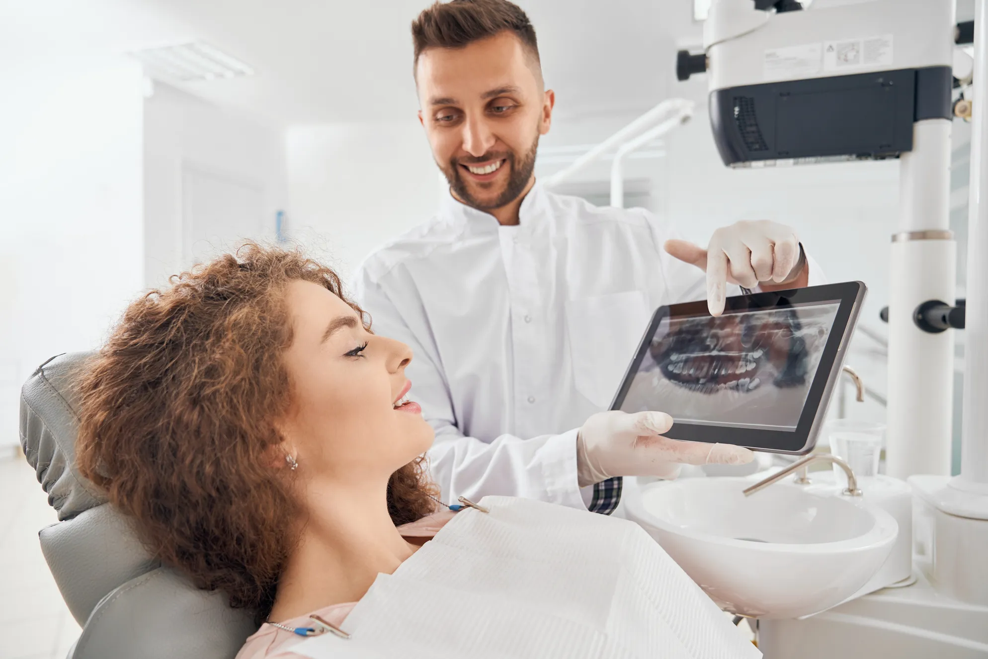 male-doctor-showing-xray-pictures-teeth-tablet (1).jpg
