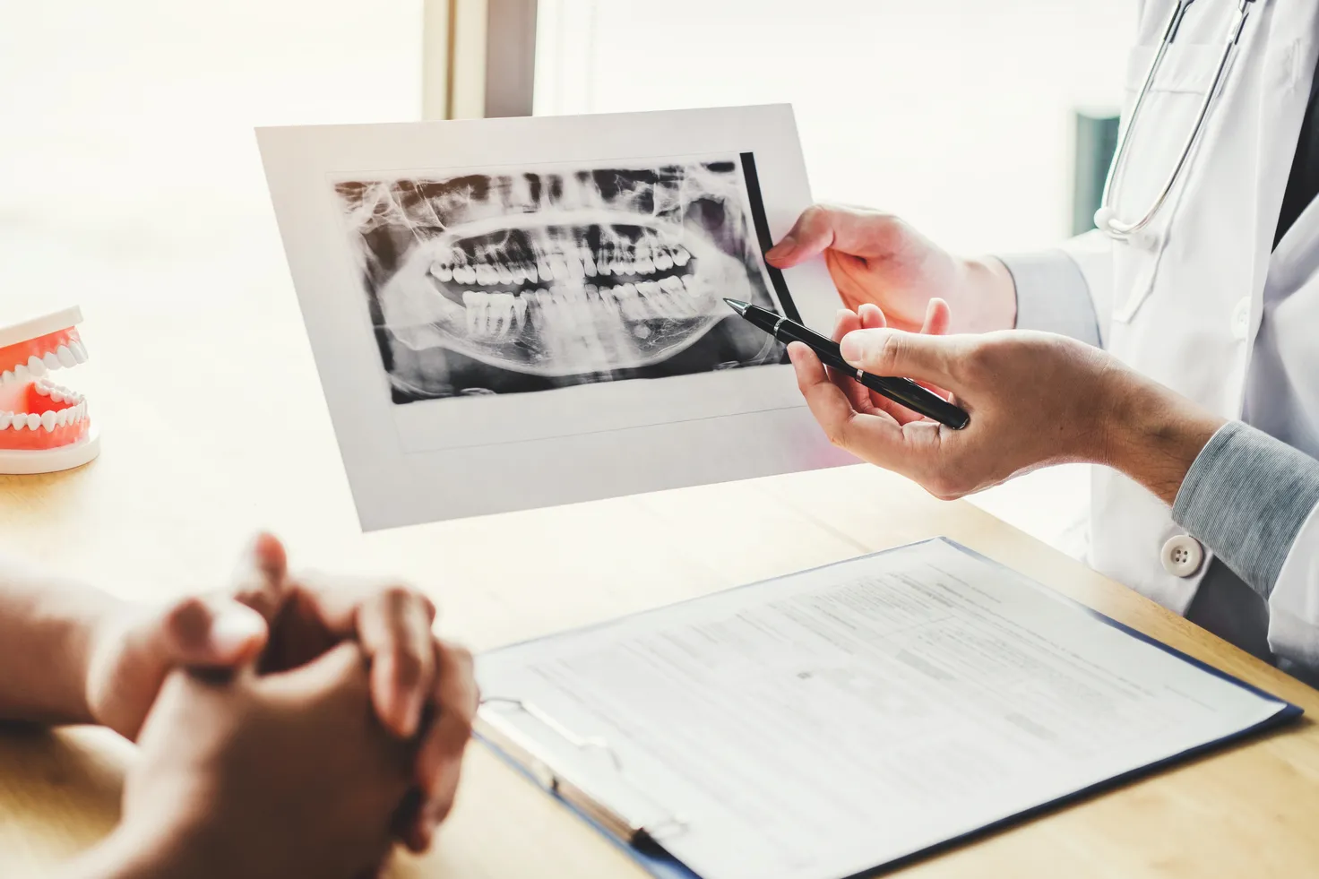 midsection-male-dentist-explaining-x-ray-patient-hospital (1).jpg