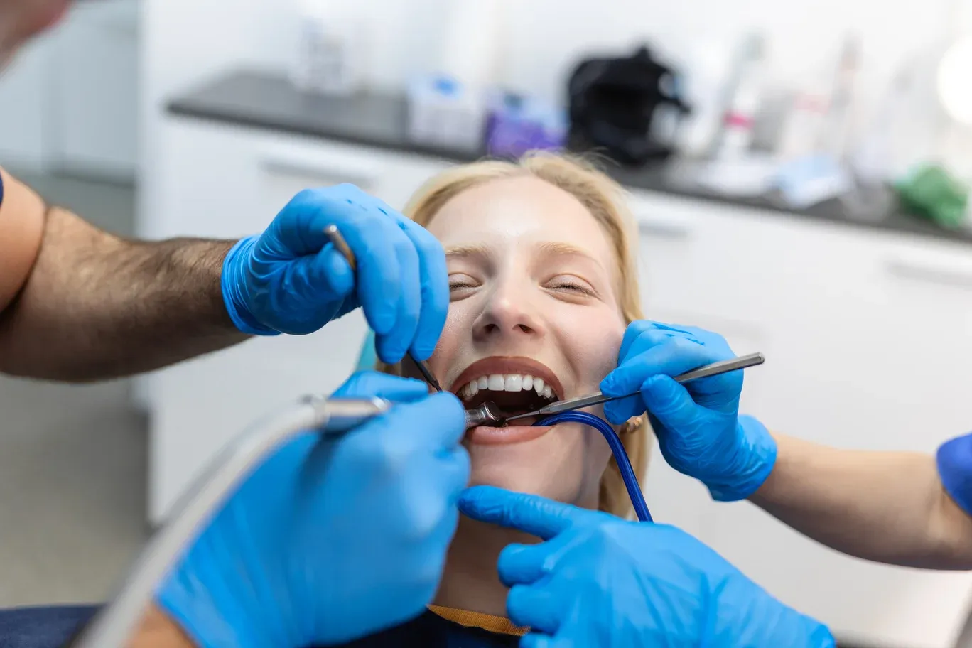 closeup-dental-drill-procedure-dentist-approaching-patient-with-dental-instruments-held-hands-protected-with-surgical-gloves (1).webp